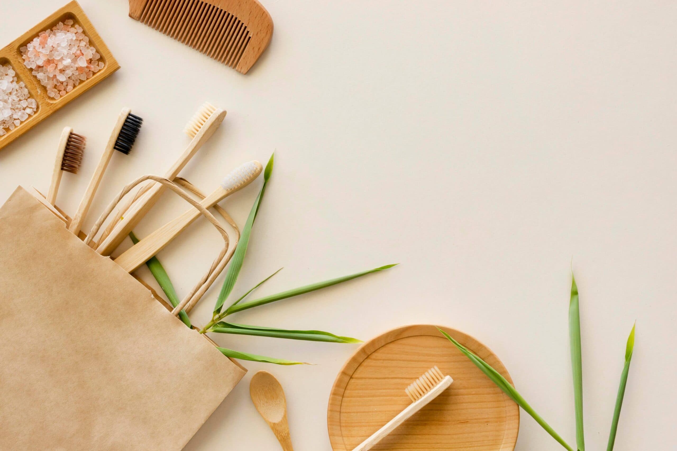 Bamboo comb, toothbrushes and himalayan salt on a beige surface