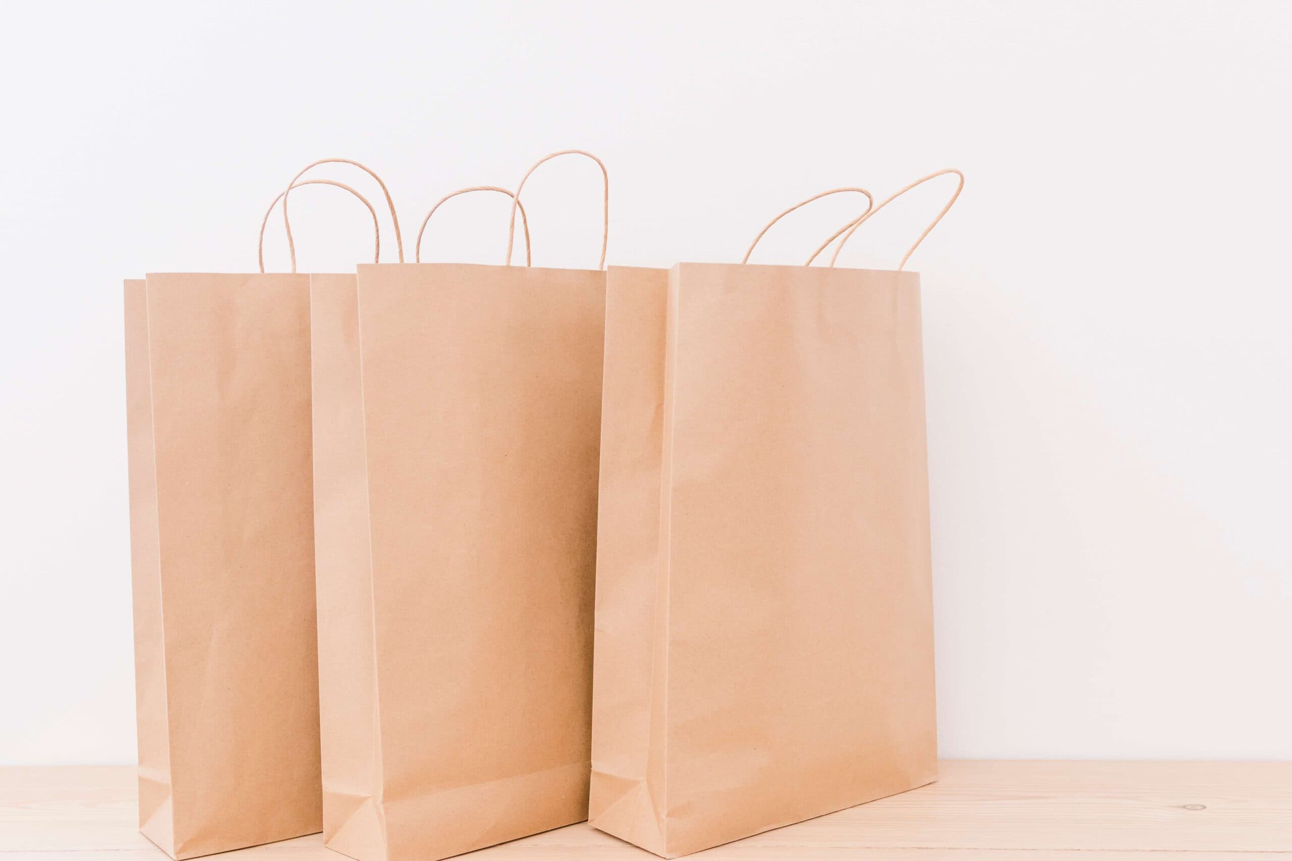Paper bags and pizza boxes stacked in a store