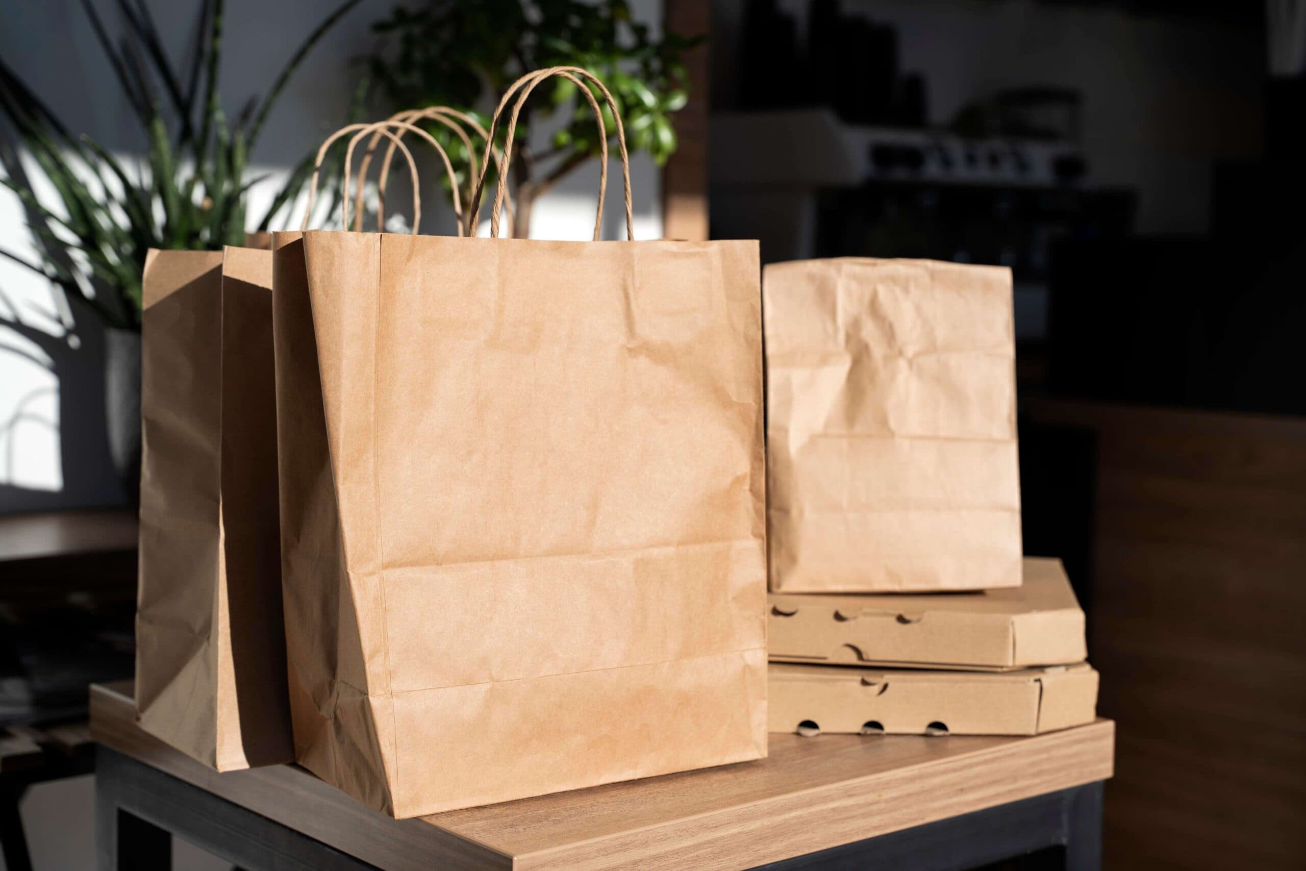 Peach-toned paper bags on a light background